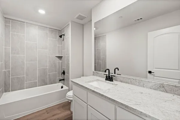 a bathroom with a sink and a bathtub with a mirror