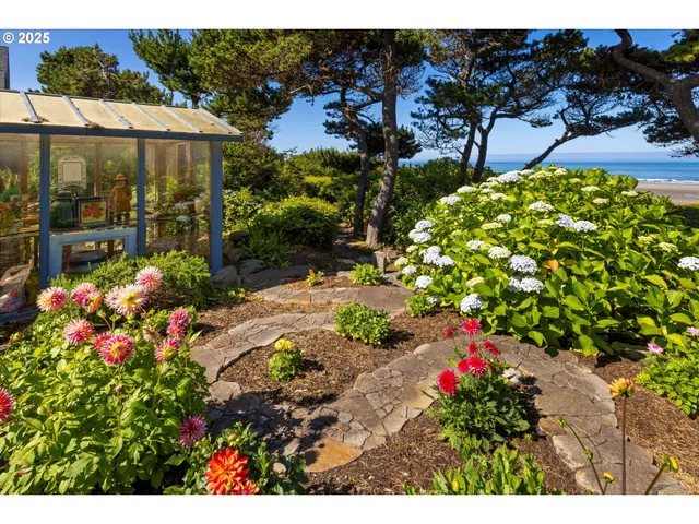 a view of a balcony with chairs and a potted plant