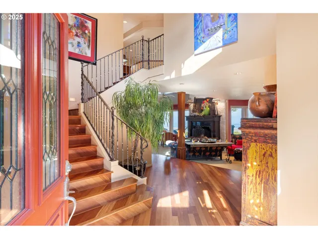 a living room with furniture a large window and a fireplace