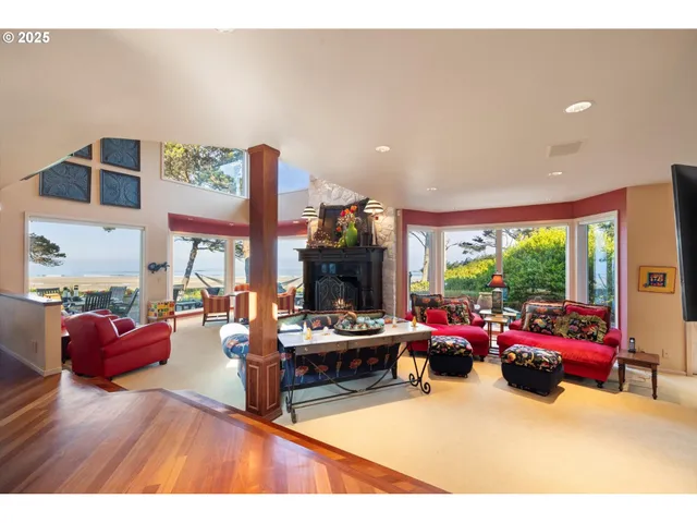 a living room with furniture a fireplace and a floor to ceiling window