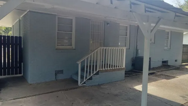 a view of a porch with a door and chair
