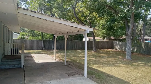a backyard of a house with a table and chairs