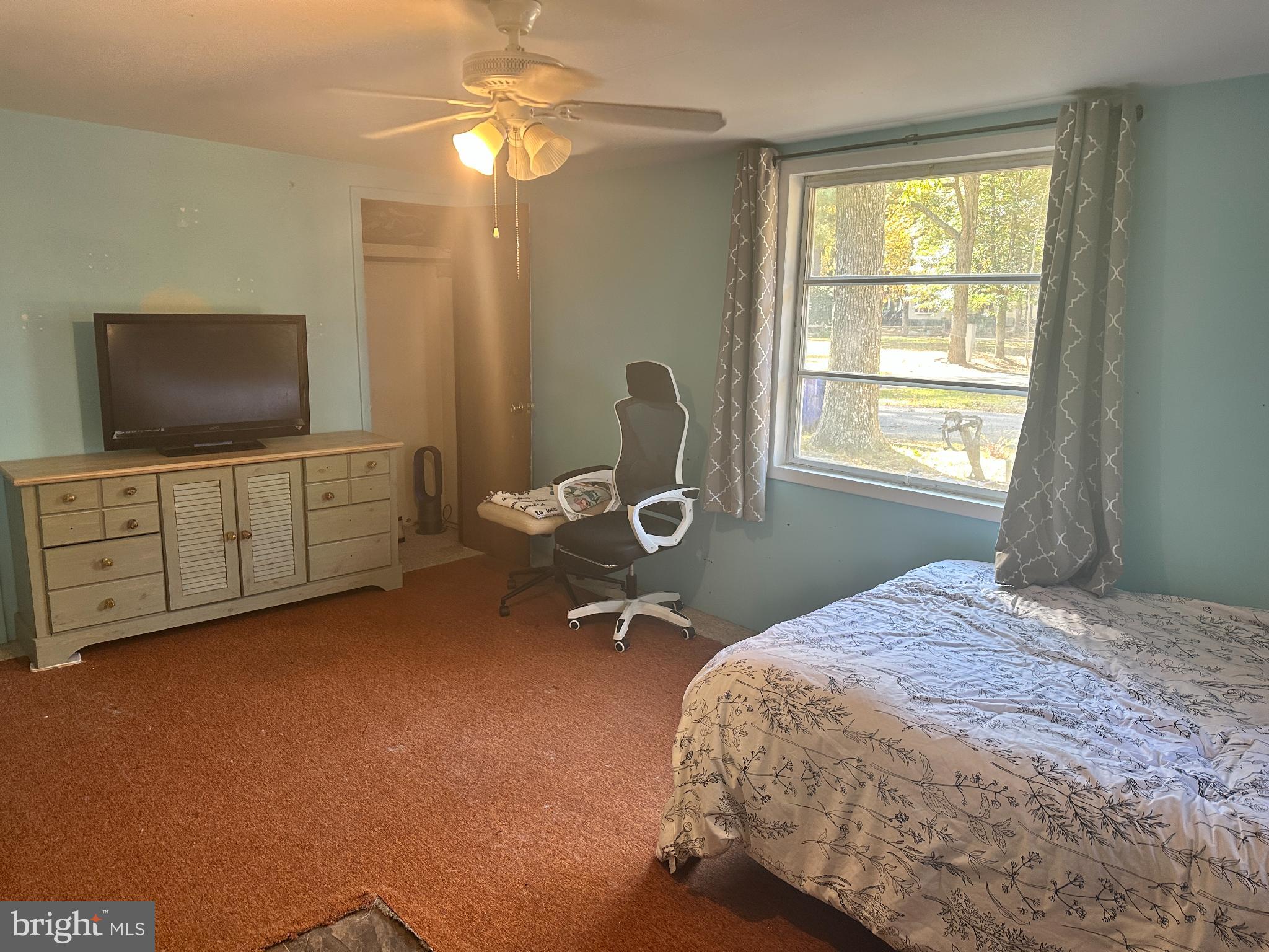34481 Broad Water Road, Unit 643 Long Neck, DE 19966 - Photo 13 of 32 a bedroom with a bed and a flat screen tv