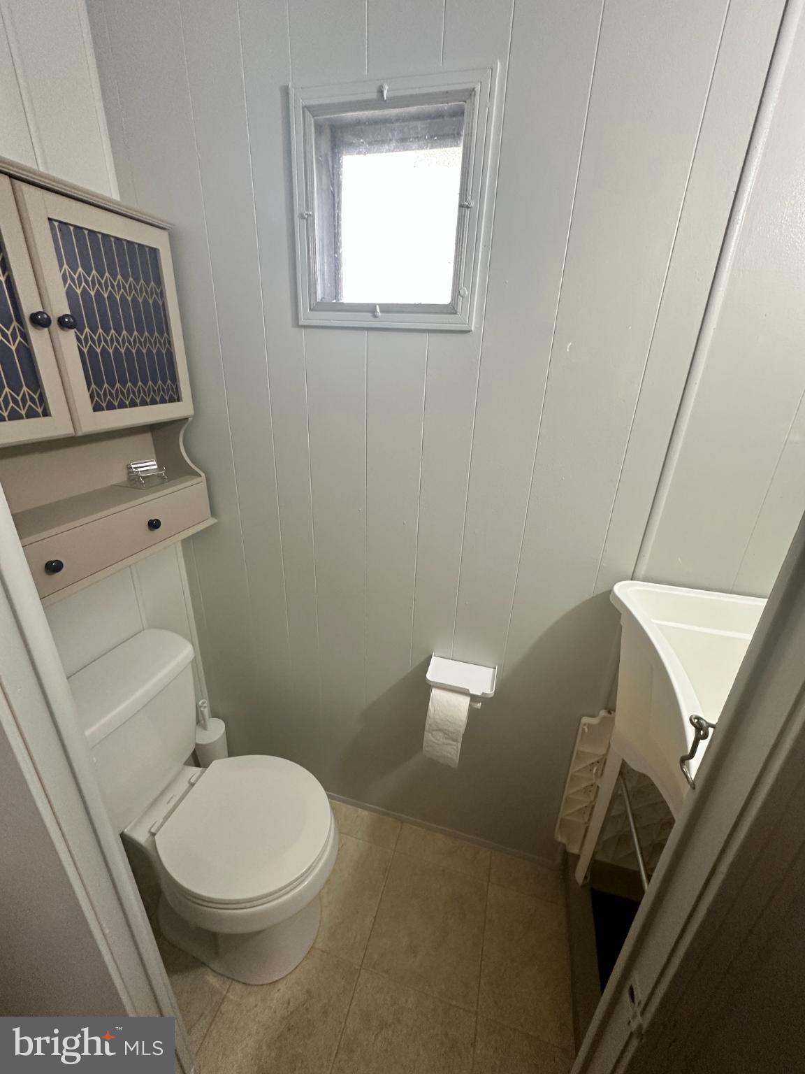 34481 Broad Water Road, Unit 643 Long Neck, DE 19966 - Photo 20 of 21 a white toilet sitting next to a bathroom sink