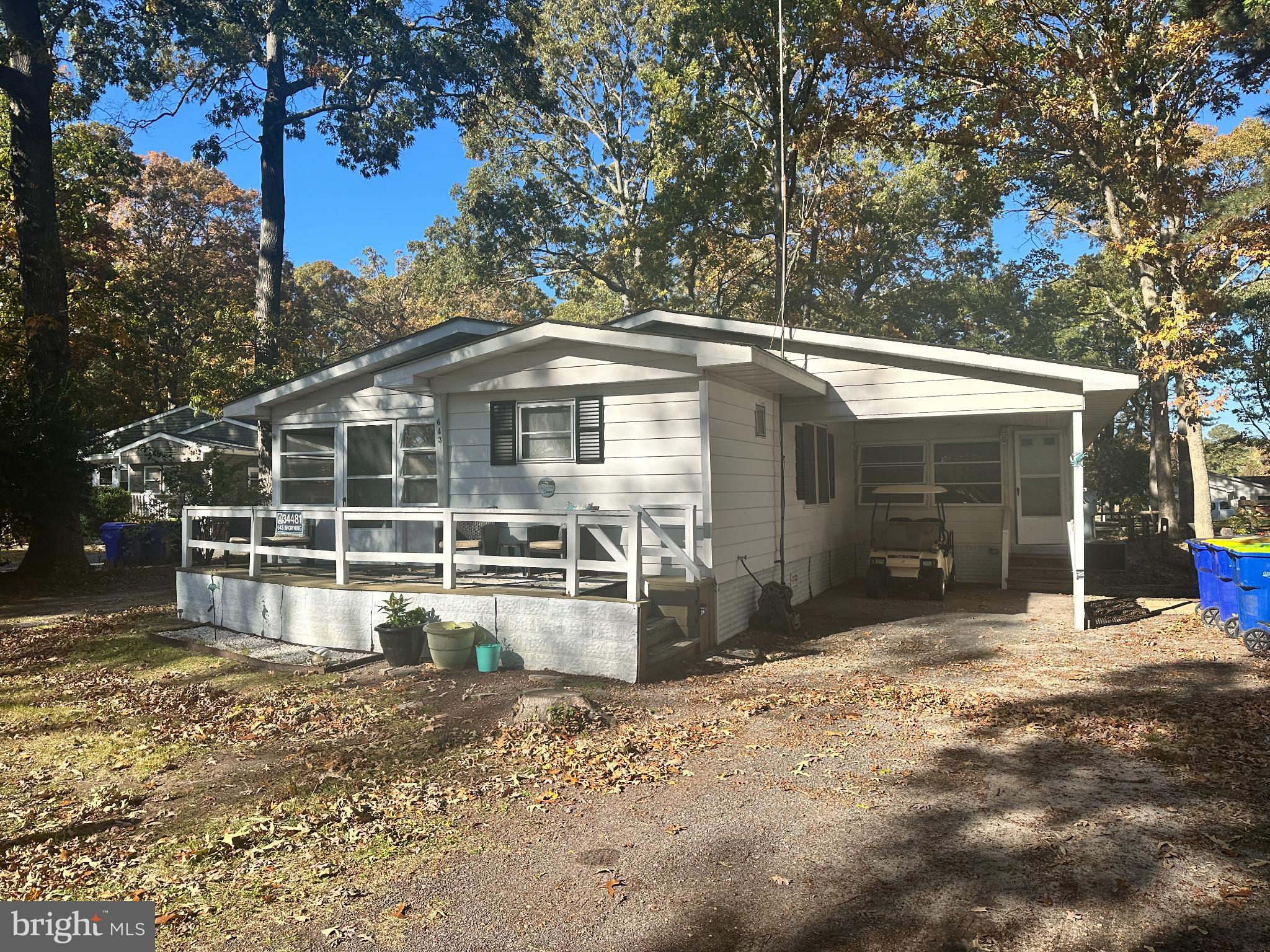 34481 Broad Water Road, Unit 643 Long Neck, DE 19966 - Photo 3 of 21 a front view of a house with a yard covered with trees