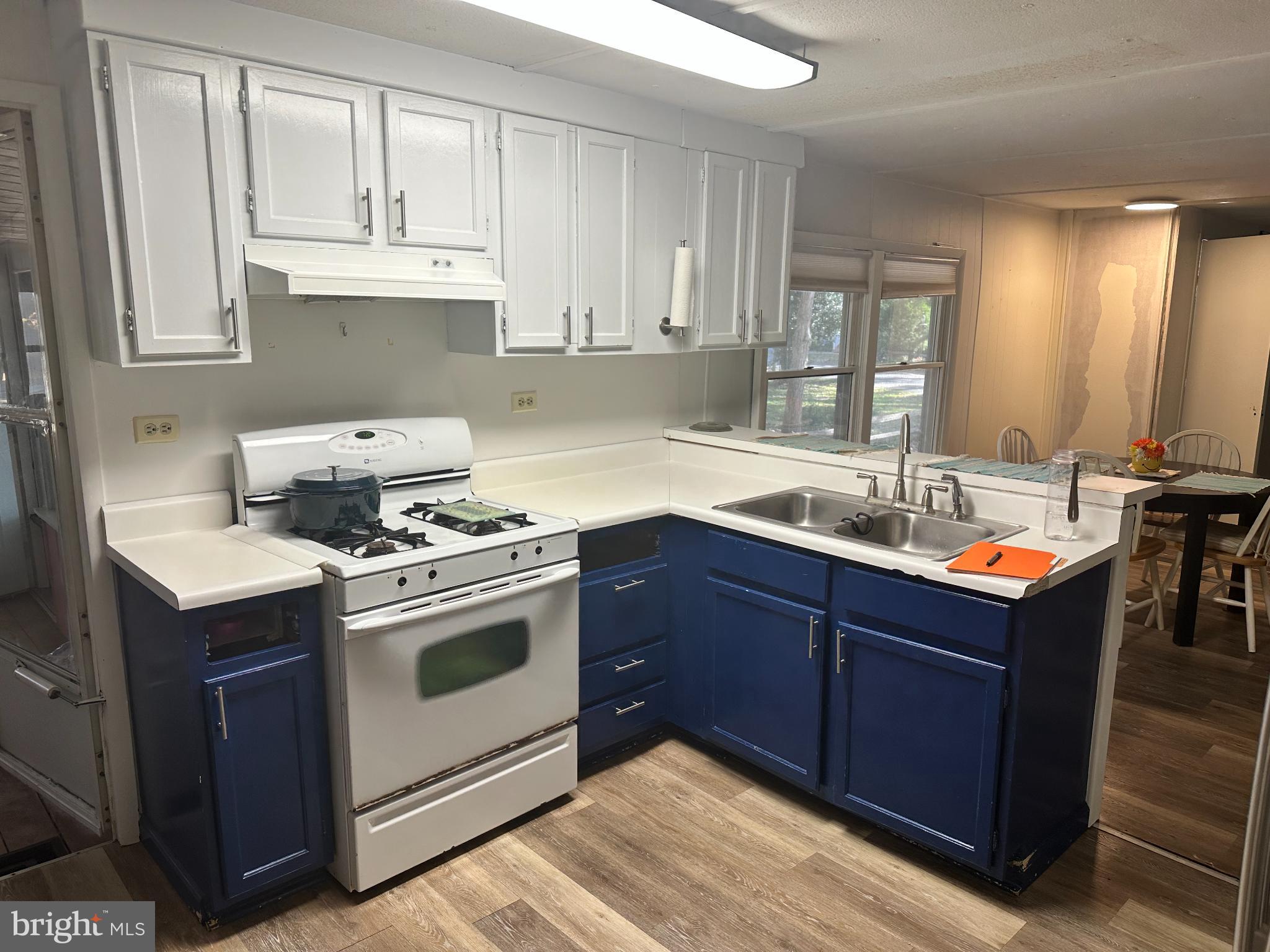 34481 Broad Water Road, Unit 643 Long Neck, DE 19966 - Photo 7 of 21 a kitchen with a sink stove top oven and cabinets