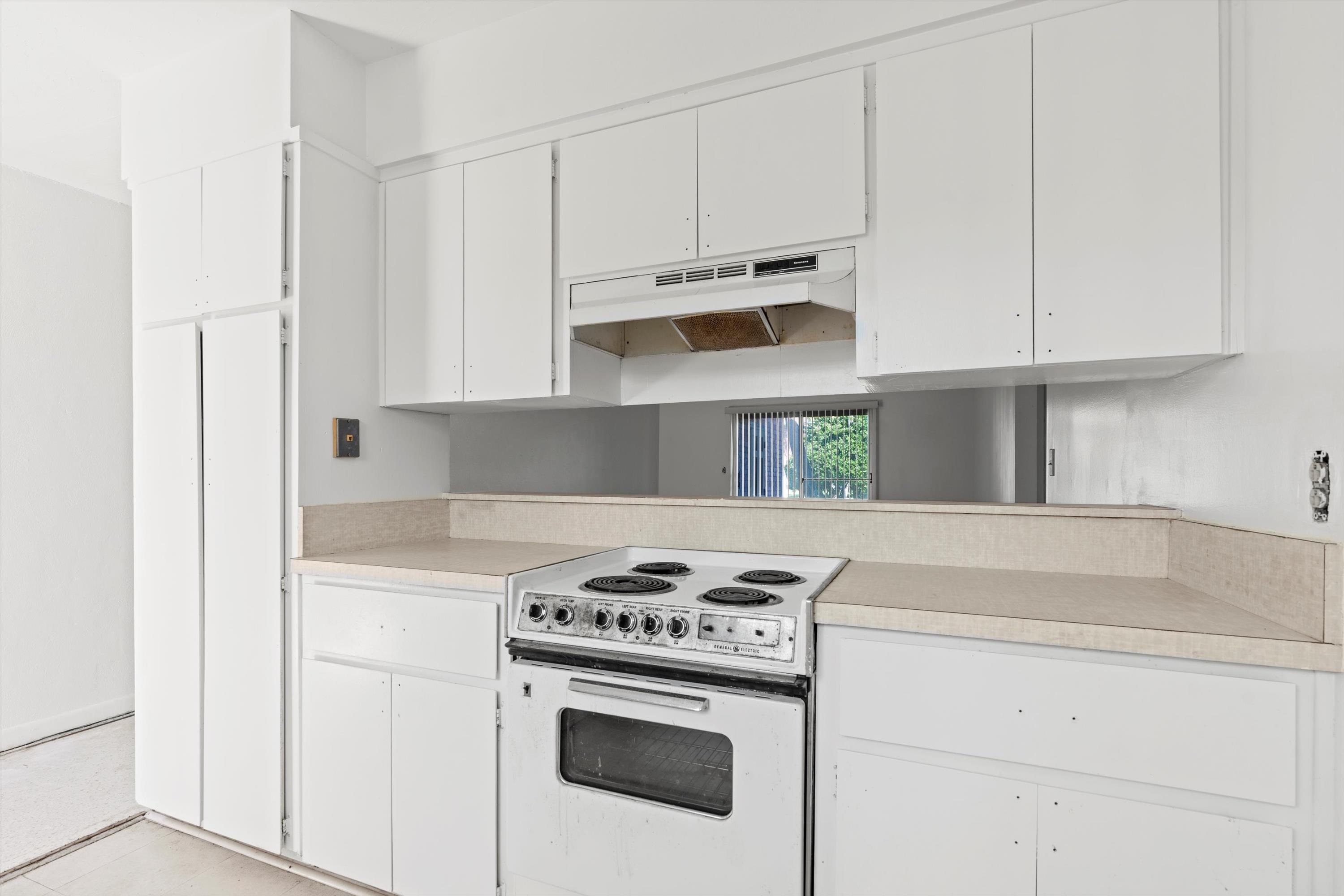 22 Comares Avenue, Unit 5B St. Augustine, FL 32080 - Photo 13 of 23 a kitchen with white cabinets and appliances