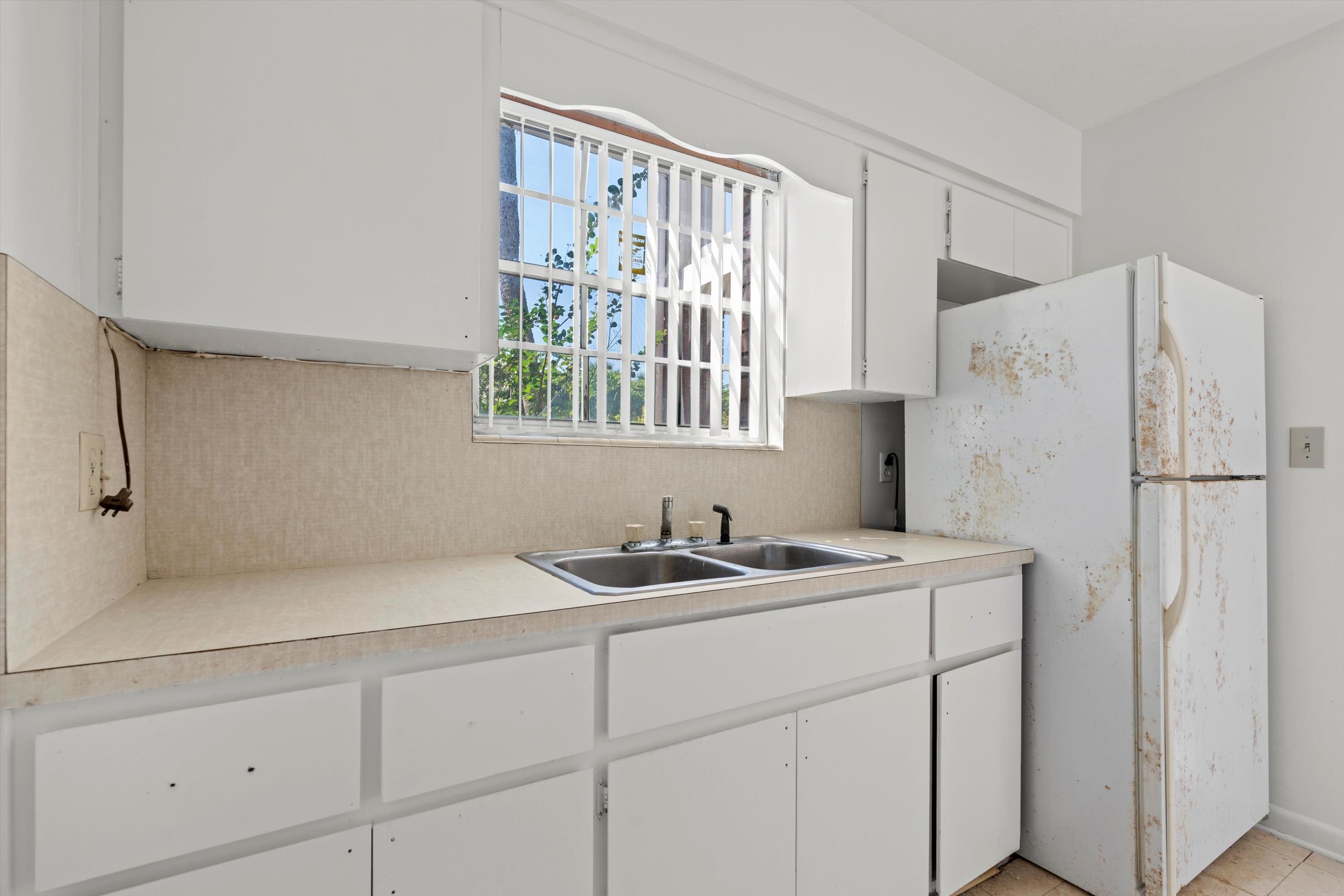 22 Comares Avenue, Unit 5B St. Augustine, FL 32080 - Photo 14 of 23 a kitchen with a sink and cabinets
