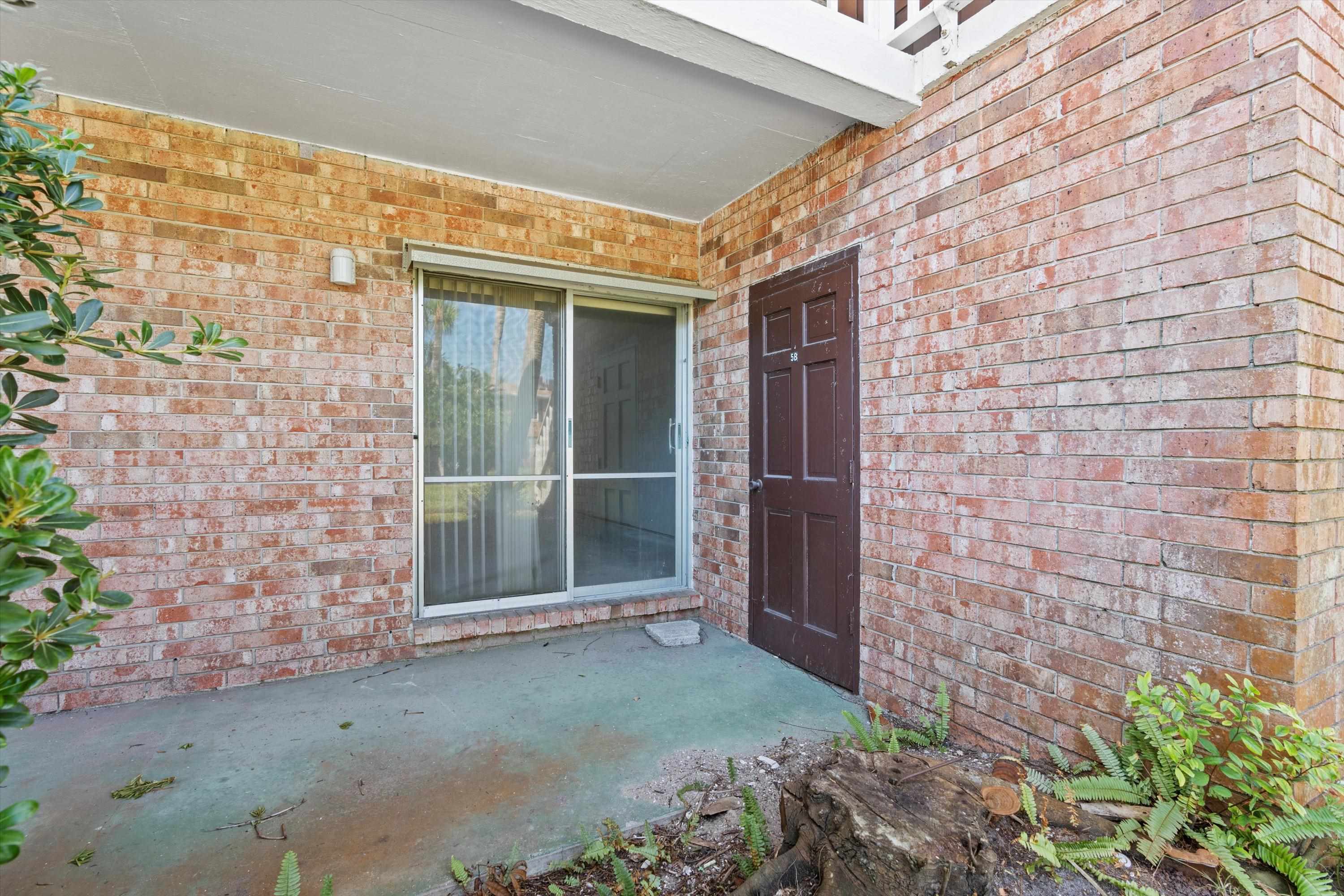 22 Comares Avenue, Unit 5B St. Augustine, FL 32080 - Photo 23 of 23 a view of a brick house with a large window