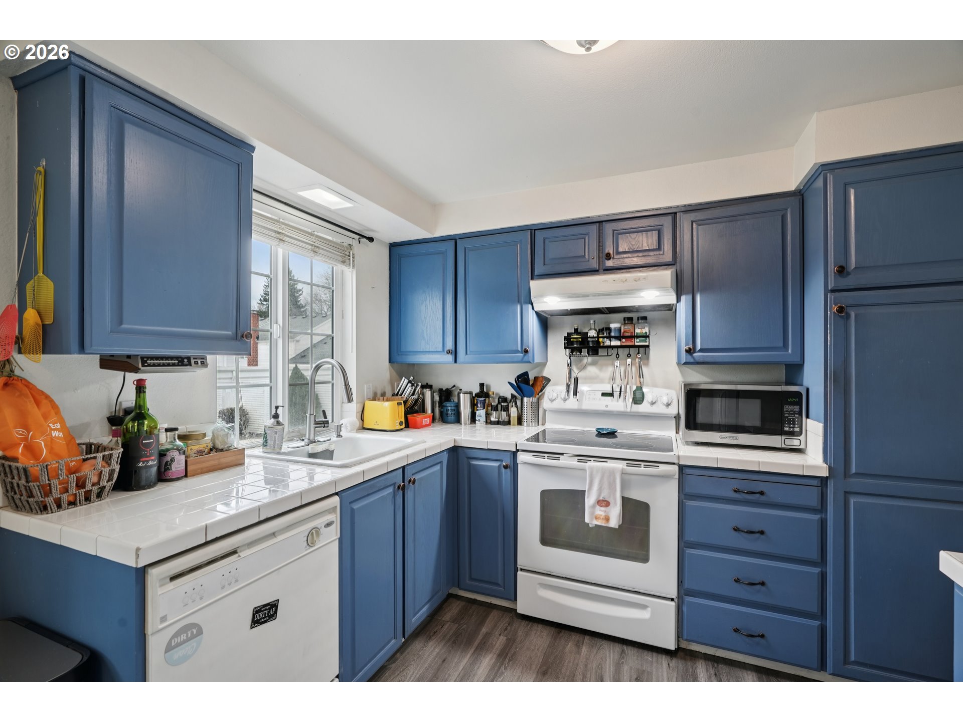 13050 Southwest 17th Street Beaverton, OR 97008 - Photo 16 of 35 a kitchen with stainless steel appliances granite countertop a stove a sink dishwasher and a refrigerator