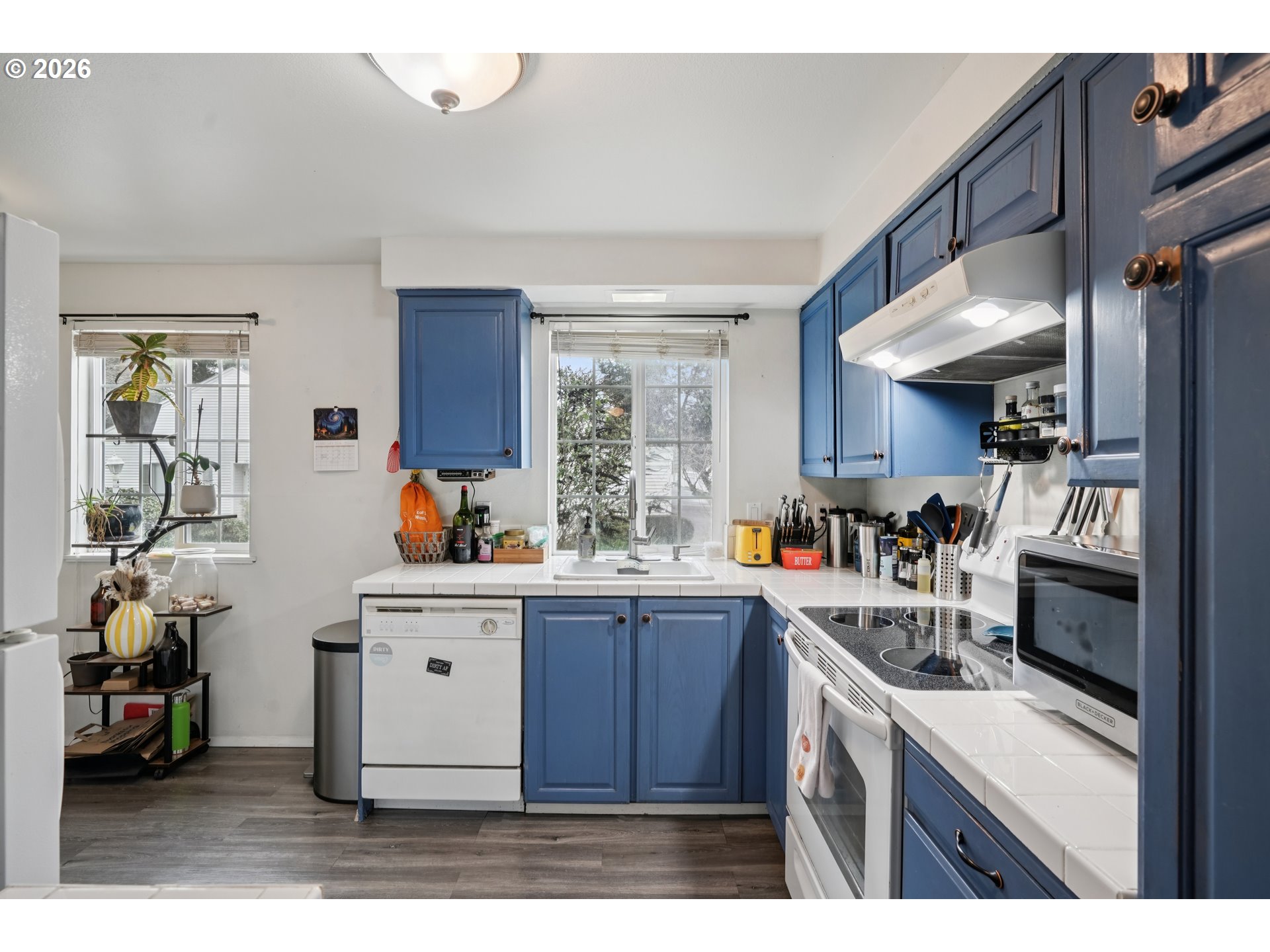 13050 Southwest 17th Street Beaverton, OR 97008 - Photo 17 of 35 a kitchen with a sink a stove and cabinets