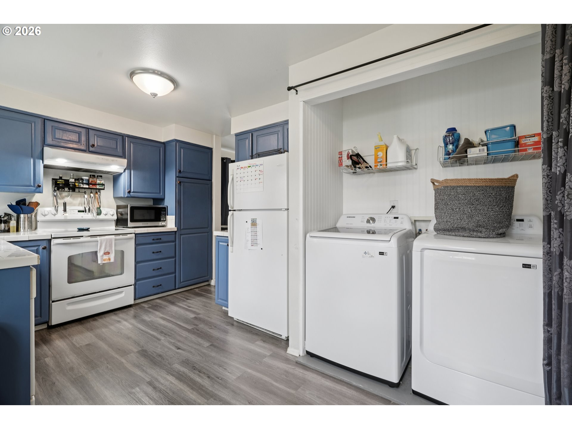 13050 Southwest 17th Street Beaverton, OR 97008 - Photo 18 of 35 a kitchen with a refrigerator sink and wooden cabinets