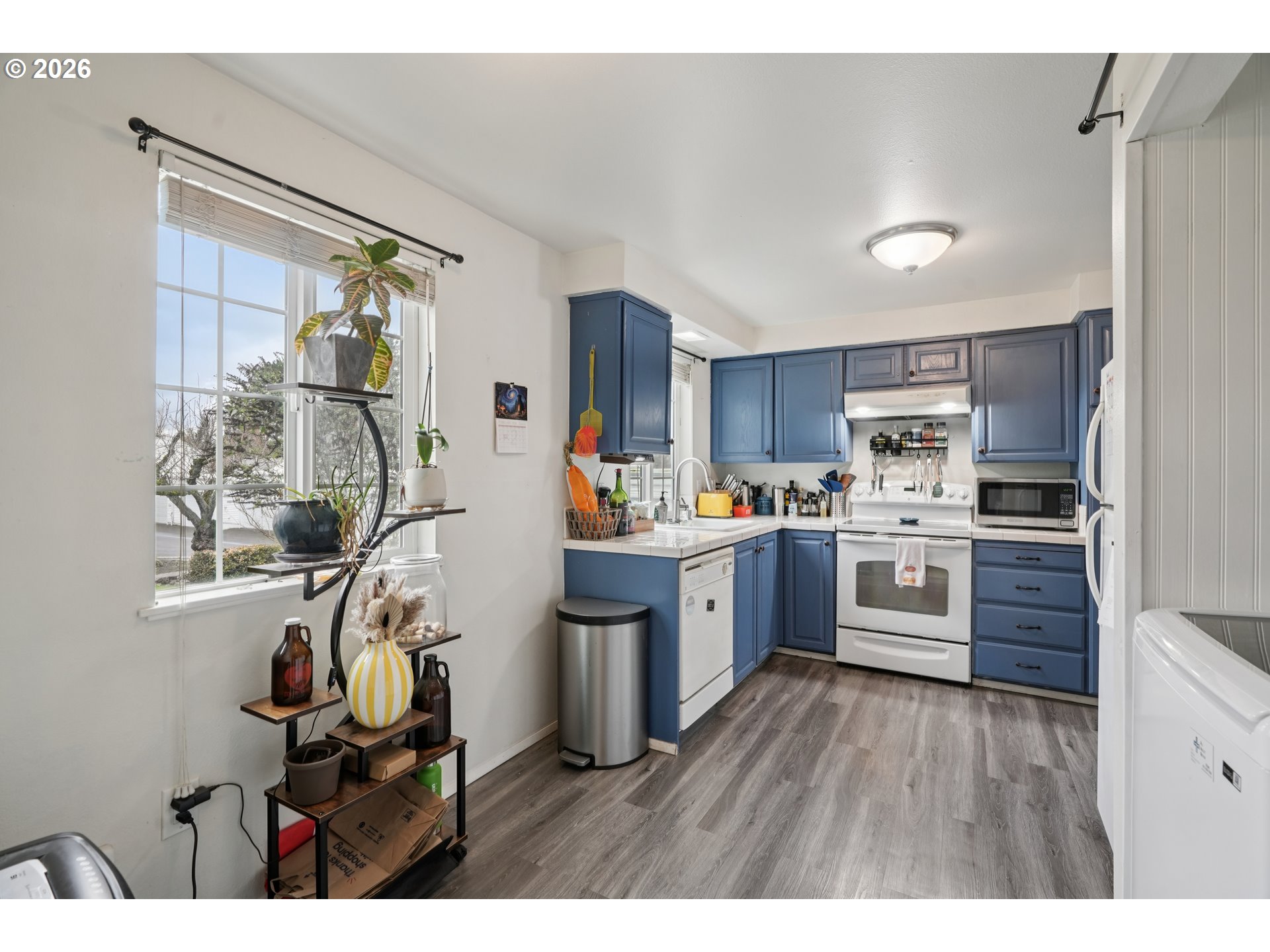 13050 Southwest 17th Street Beaverton, OR 97008 - Photo 20 of 35 a kitchen with a refrigerator a sink and cabinets