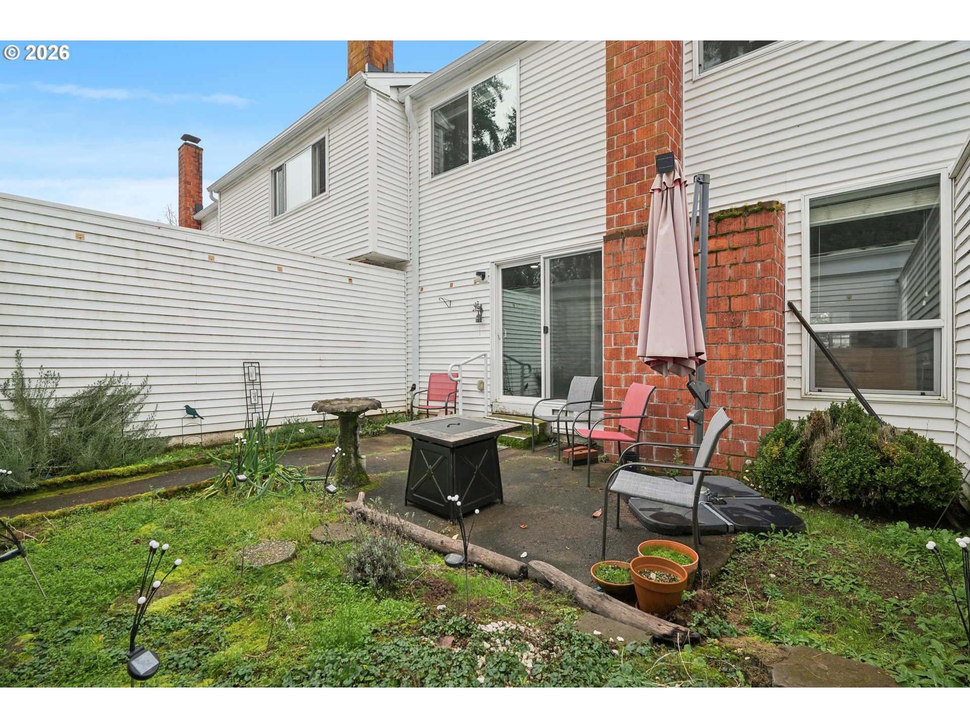 13050 Southwest 17th Street Beaverton, OR 97008 - Photo 31 of 35 a view of a house with backyard sitting area and garden