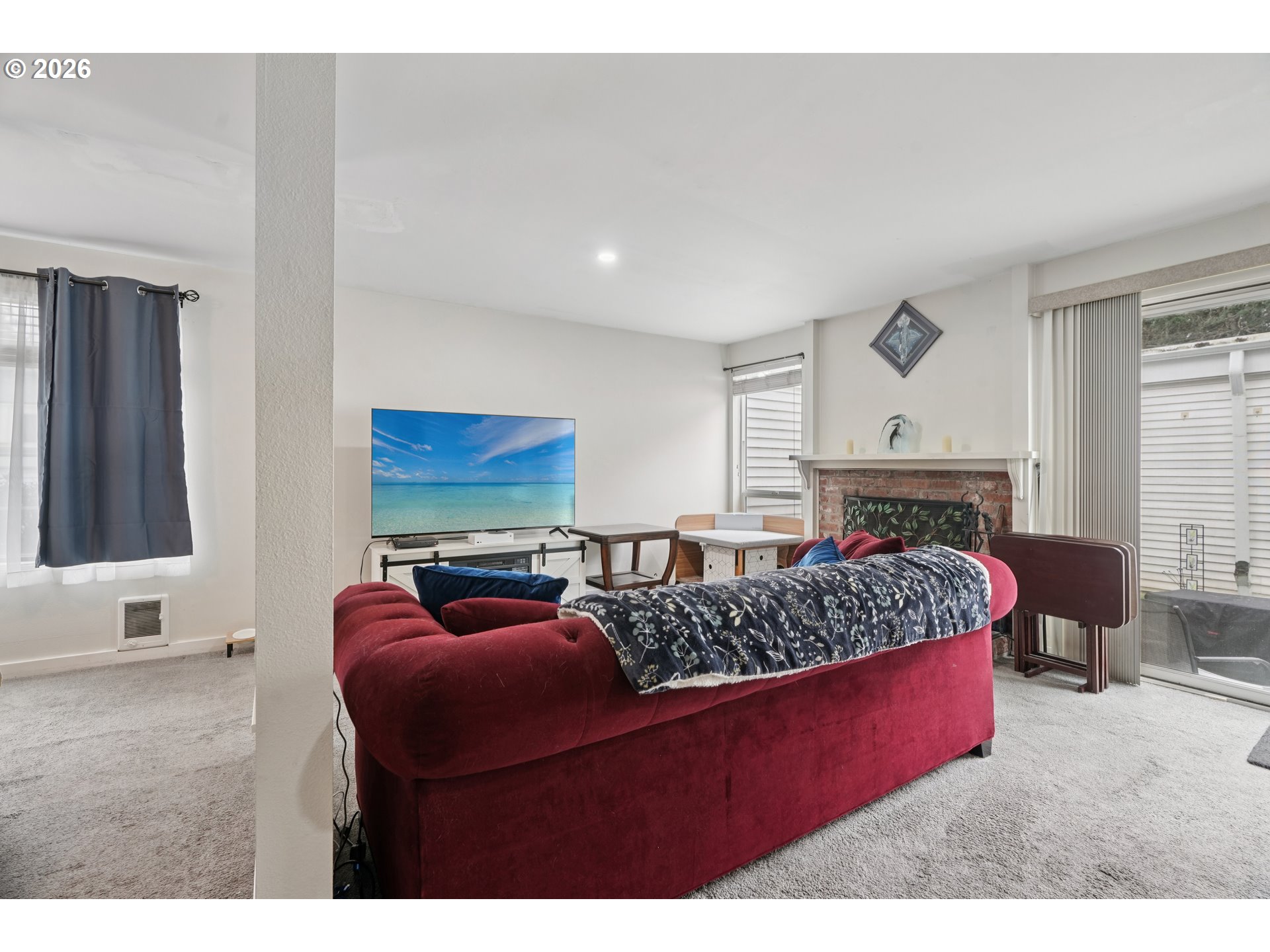 13050 Southwest 17th Street Beaverton, OR 97008 - Photo 8 of 35 a living room with furniture a fireplace and a flat screen tv
