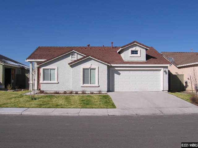 1753 Camaraderie Way Reno, NV 89521 - Photo 1 of 8 a front view of a house with a yard and garage