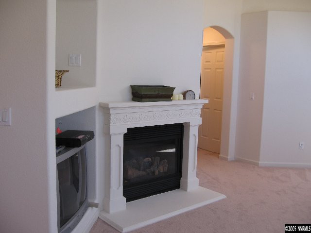 1753 Camaraderie Way Reno, NV 89521 - Photo 6 of 8 a living room with a fireplace in it