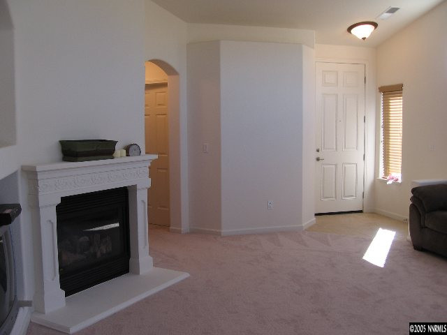 1753 Camaraderie Way Reno, NV 89521 - Photo 8 of 8 a living room with furniture and a fireplace