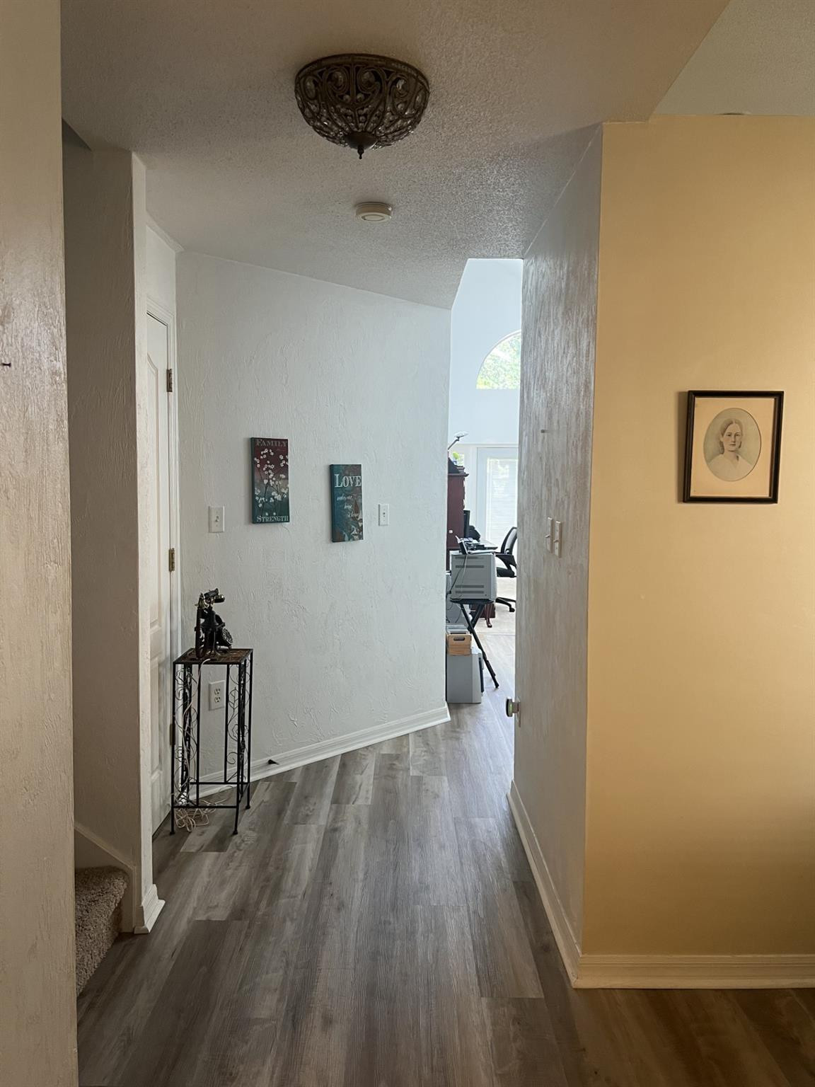 539 Lake Bridge Drive Ormond Beach, FL 32174 - Photo 20 of 34 a view of a hallway with wooden floor and a bathroom