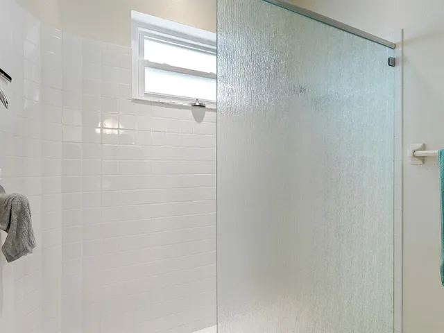 a bathroom with a glass shower door