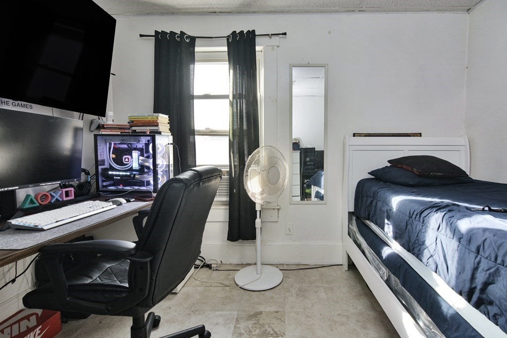 210 Ferry Street Lawrence, MA 01841 - Photo 11 of 24 a view of a livingroom with furniture and a flat screen tv
