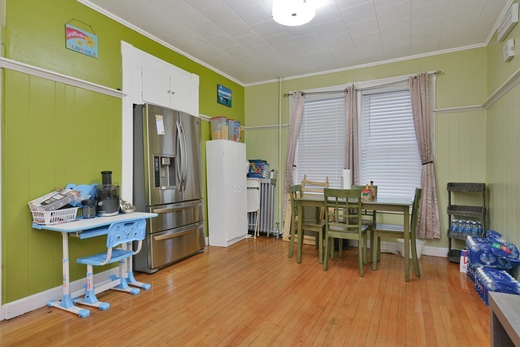 210 Ferry Street Lawrence, MA 01841 - Photo 16 of 24 a dining room with furniture and wooden floor