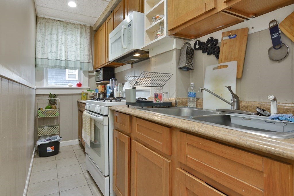 210 Ferry Street Lawrence, MA 01841 - Photo 18 of 24 a kitchen with a sink and cabinets