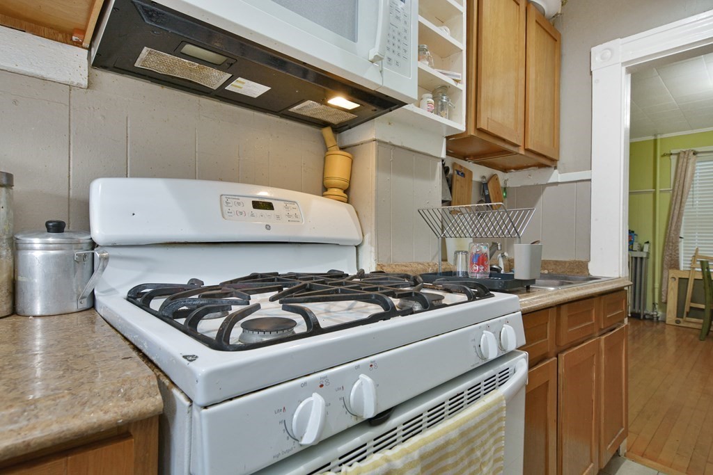 210 Ferry Street Lawrence, MA 01841 - Photo 19 of 24 a white stove top oven sitting inside of a kitchen
