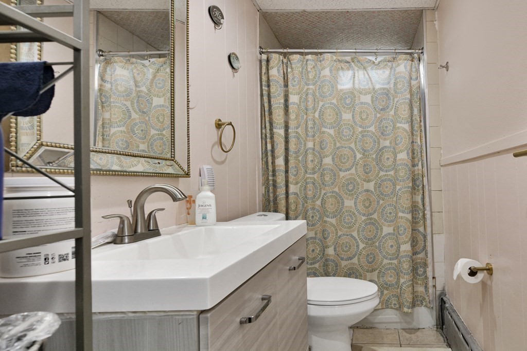 210 Ferry Street Lawrence, MA 01841 - Photo 20 of 24 a bathroom with a sink toilet and shower