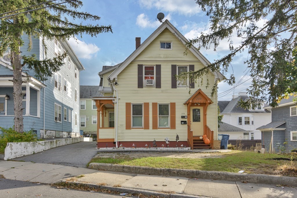 210 Ferry Street Lawrence, MA 01841 - Photo 2 of 24 a front view of a house with a yard