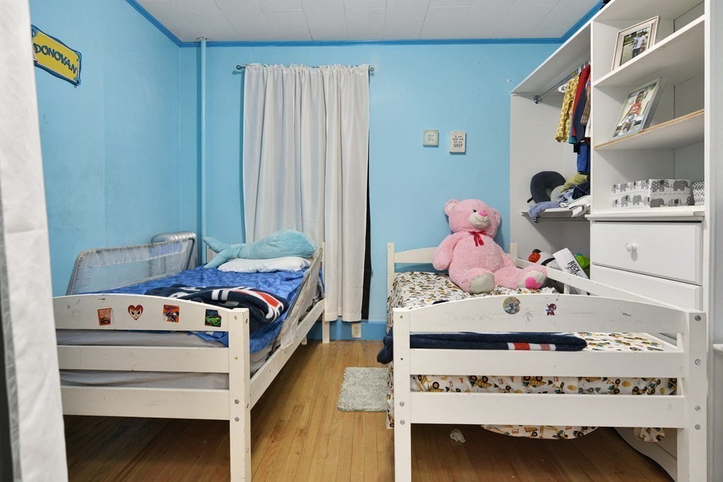 210 Ferry Street Lawrence, MA 01841 - Photo 21 of 24 a bedroom with a bed and dresser