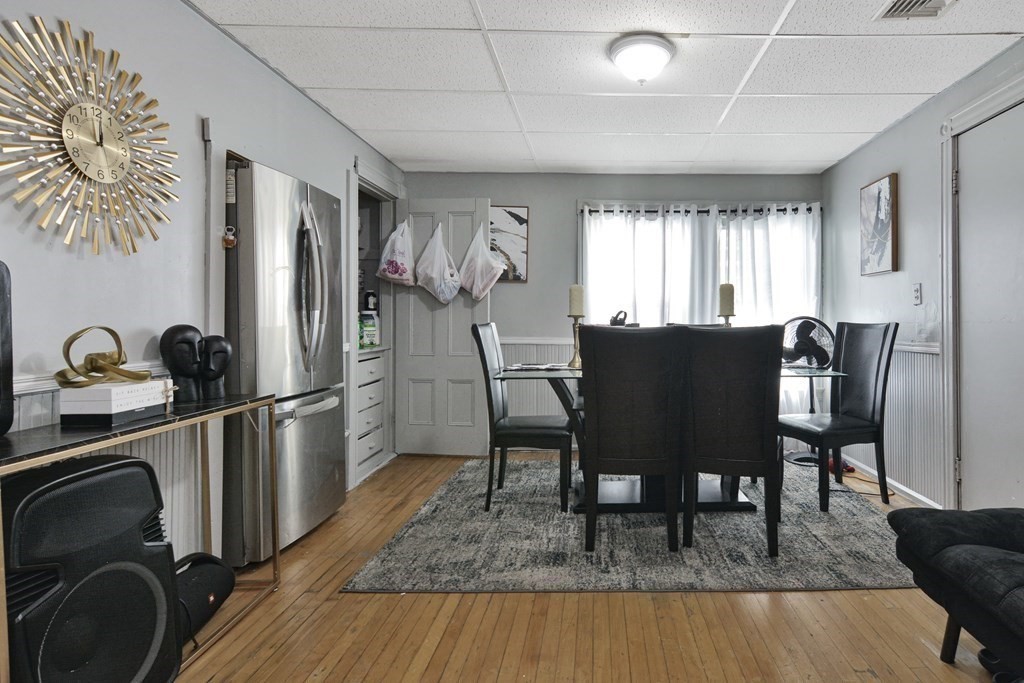 210 Ferry Street Lawrence, MA 01841 - Photo 3 of 24 a view of a dining room with furniture and a rug
