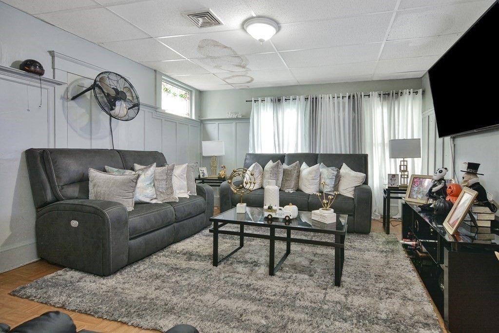 210 Ferry Street Lawrence, MA 01841 - Photo 7 of 24 a living room with furniture and a flat screen tv