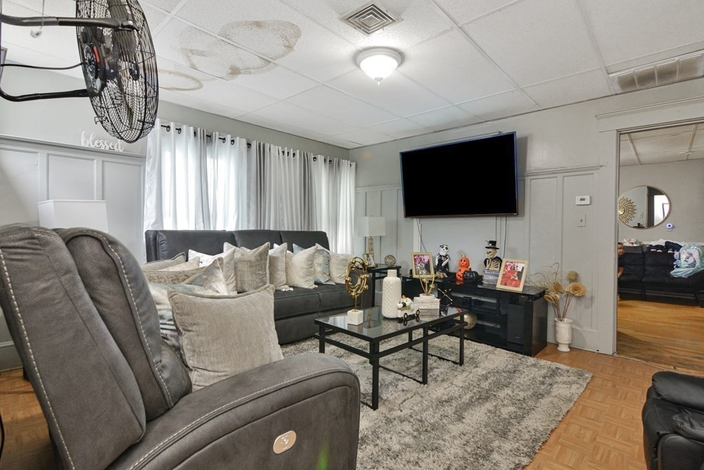 210 Ferry Street Lawrence, MA 01841 - Photo 8 of 24 a living room with furniture and a flat screen tv