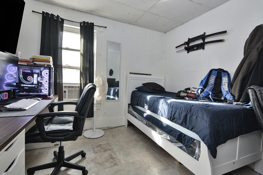 210 Ferry Street Lawrence, MA 01841 - Photo 10 of 24 a bedroom with furniture and a window