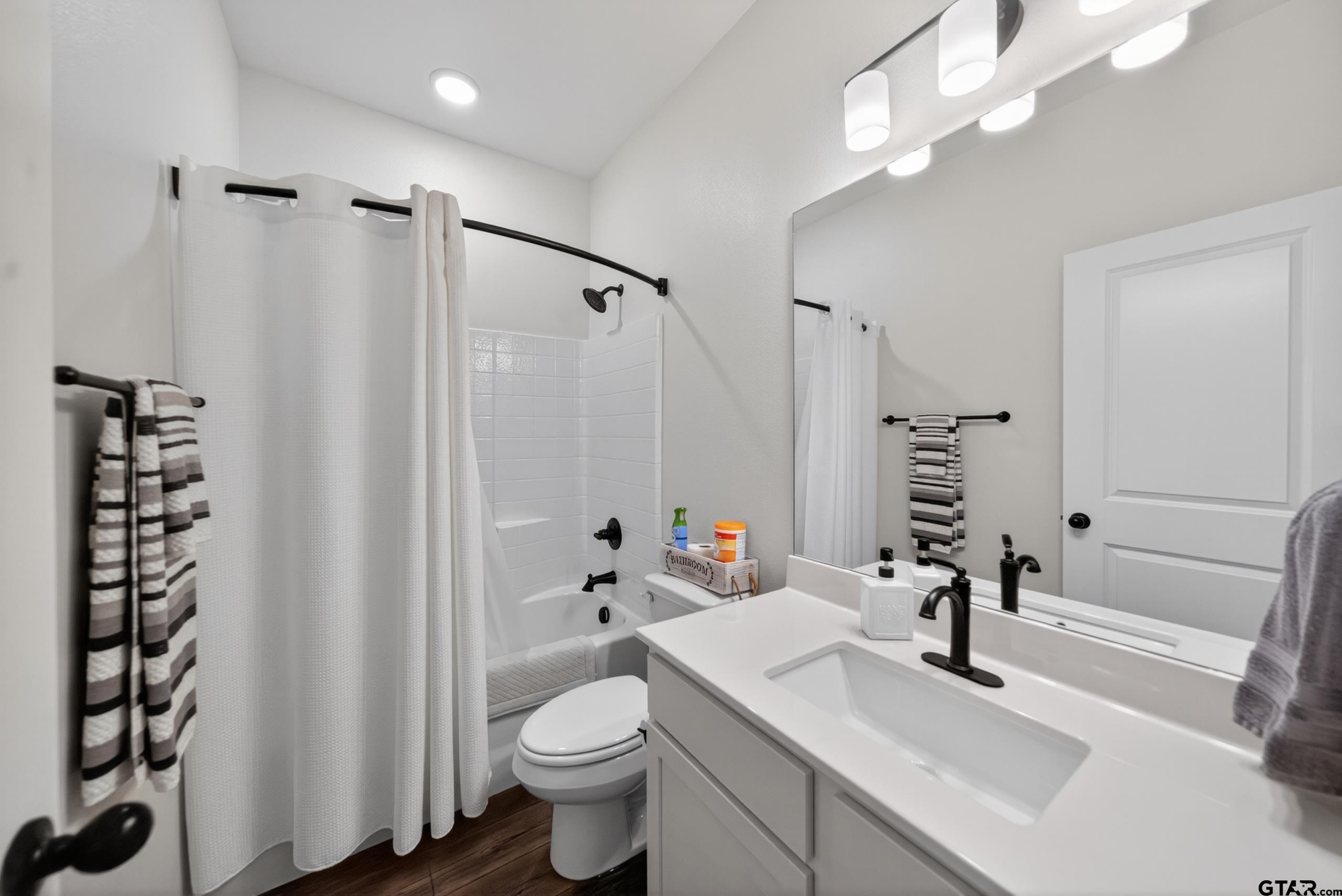 7836 Freestone Drive Bullard, TX 75757 - Photo 14 of 43 a bathroom with a sink toilet a mirror and shower