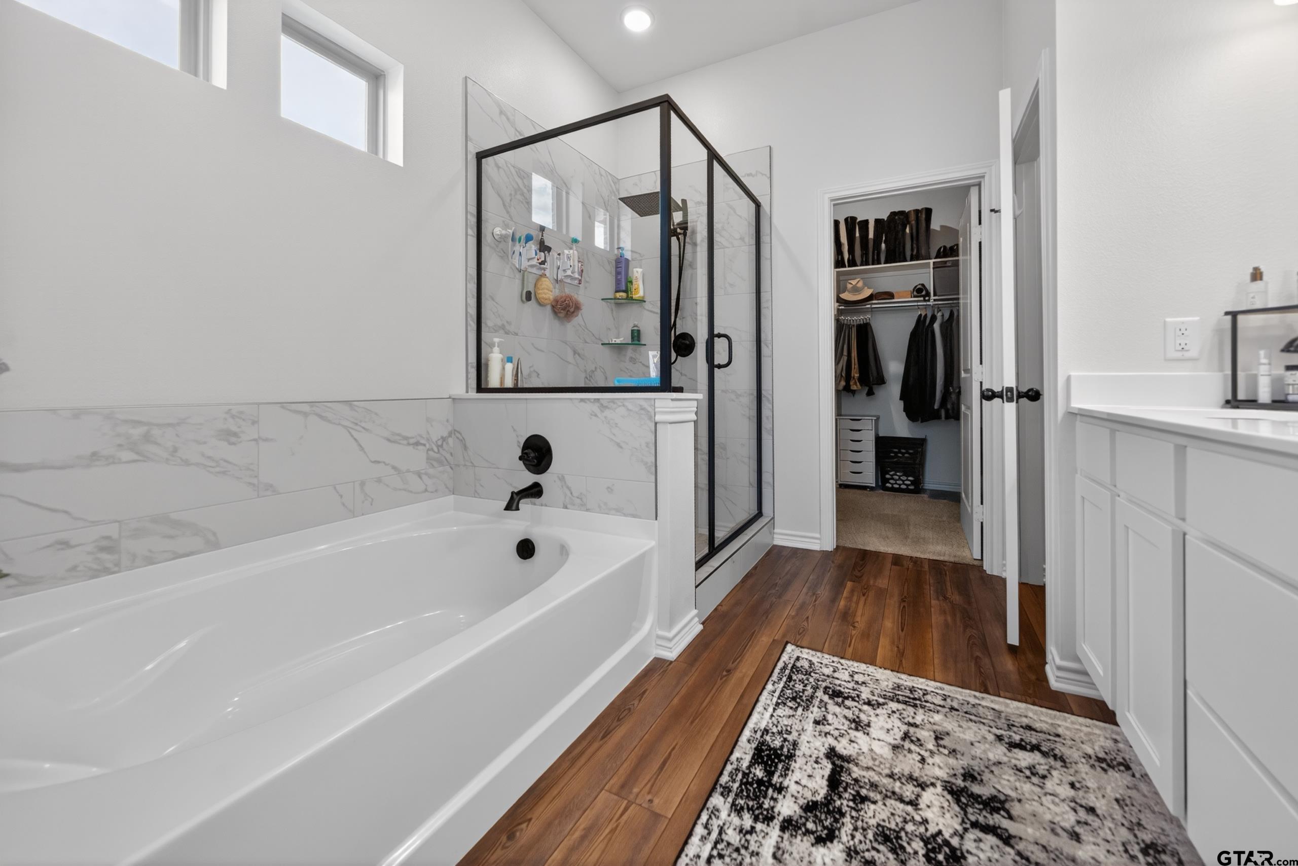 7836 Freestone Drive Bullard, TX 75757 - Photo 17 of 43 a bathroom with a bathtub and a shower
