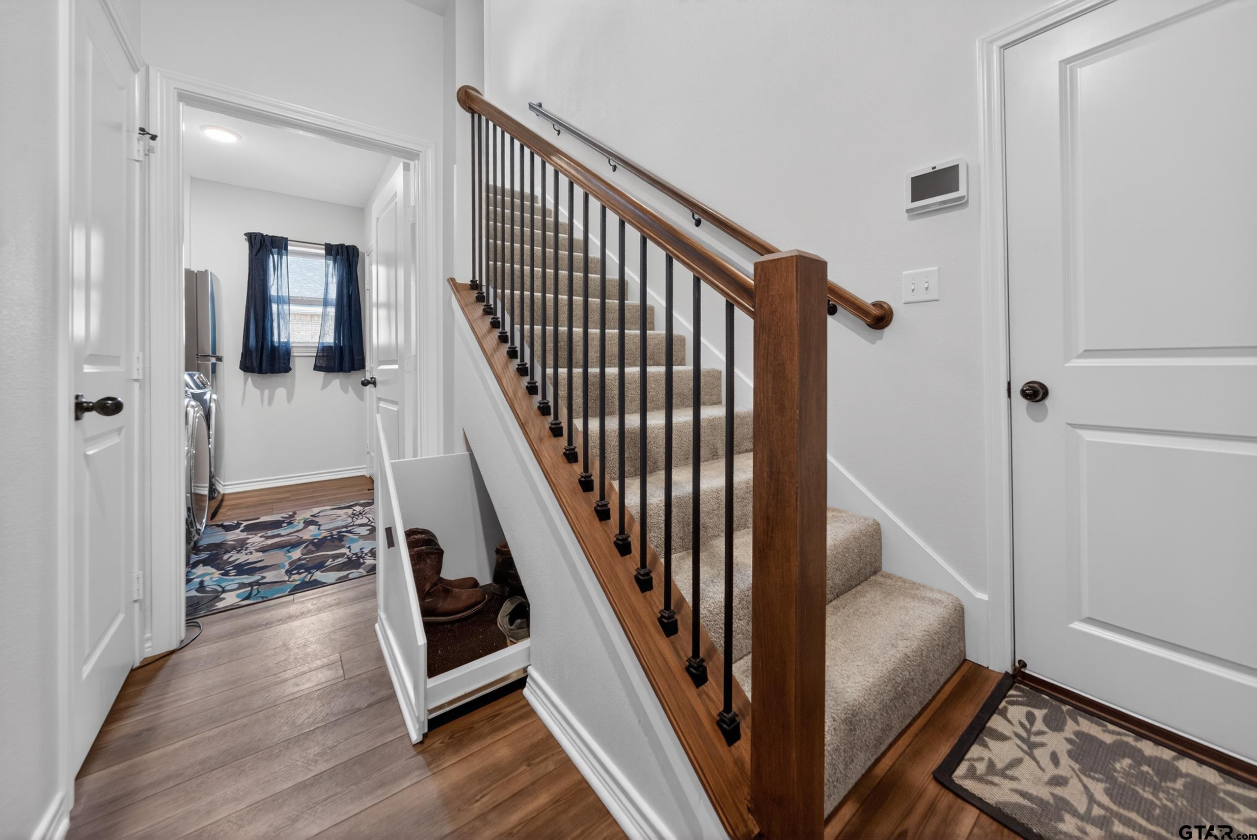 7836 Freestone Drive Bullard, TX 75757 - Photo 22 of 43 a view of a hallway with wooden floor and stairs