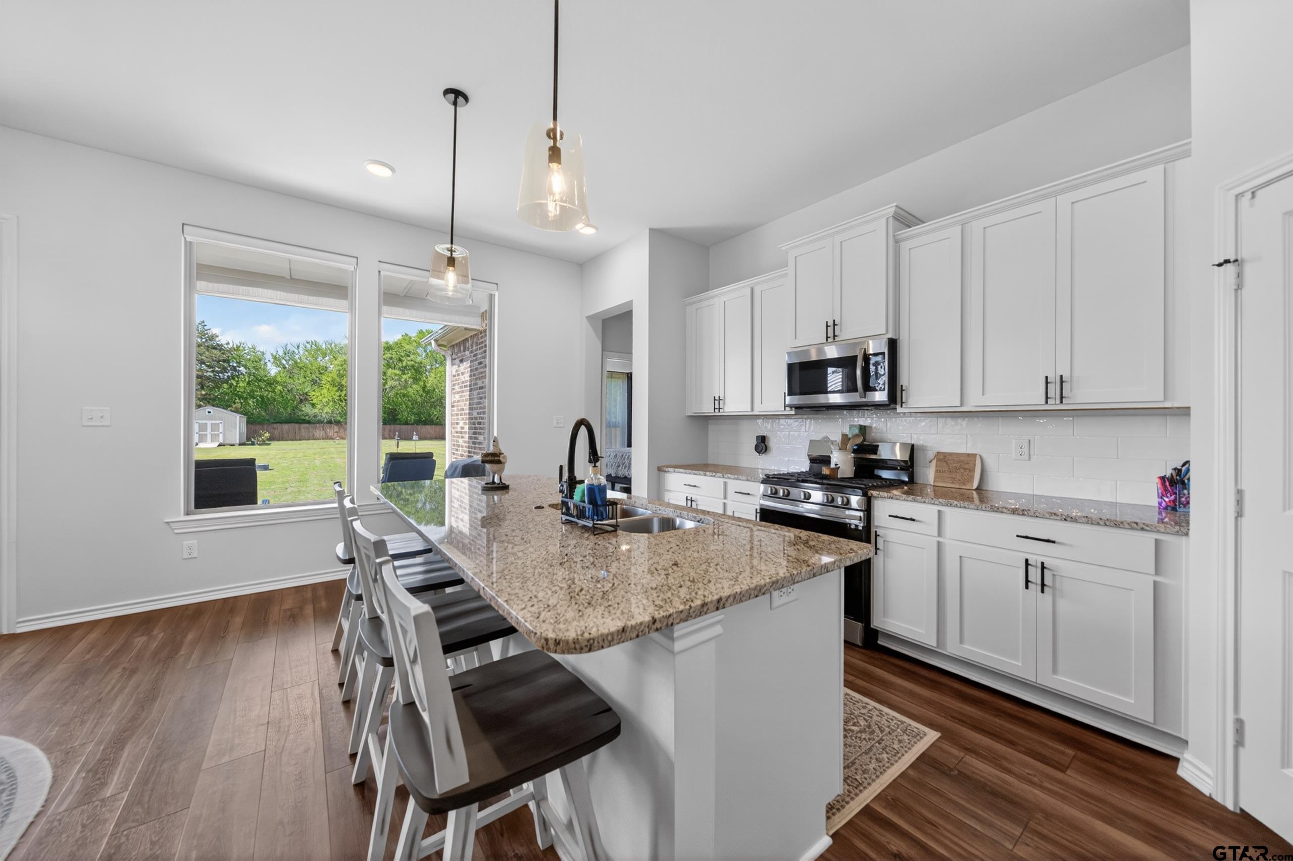 7836 Freestone Drive Bullard, TX 75757 - Photo 5 of 43 a kitchen with stainless steel appliances granite countertop sink stove top oven and cabinets
