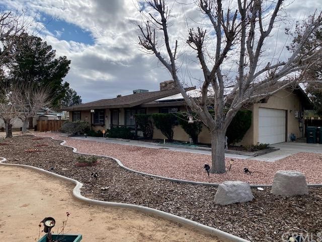 20825 Shawnee Road Apple Valley, CA 92308 - Photo 1 of 1 a front view of a house with garden