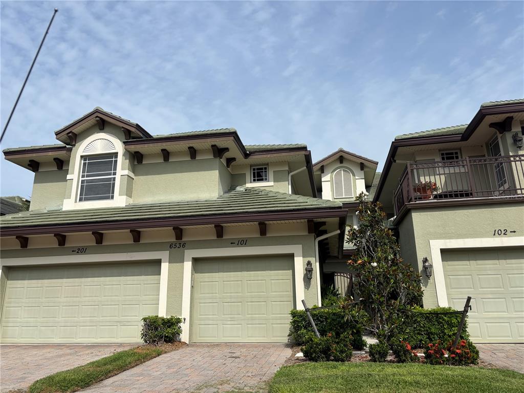 6536 Moorings Point Circle, Unit 101 Lakewood Ranch, FL 34202 - Photo 1 of 34 a front view of residential houses