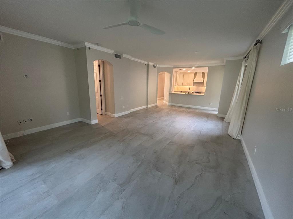 6536 Moorings Point Circle, Unit 101 Lakewood Ranch, FL 34202 - Photo 17 of 34 a view of empty room with wooden floor and fan