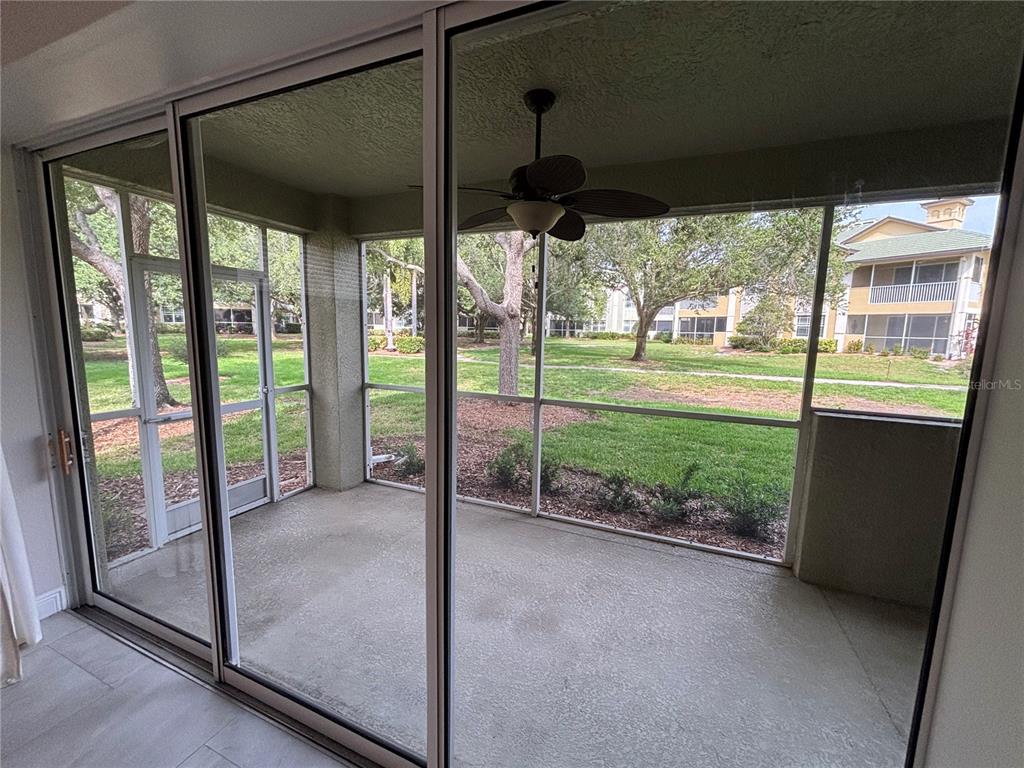 6536 Moorings Point Circle, Unit 101 Lakewood Ranch, FL 34202 - Photo 19 of 34 a view of a room with porch and wooden floor
