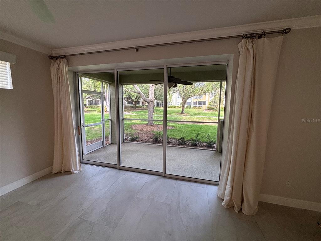 6536 Moorings Point Circle, Unit 101 Lakewood Ranch, FL 34202 - Photo 20 of 34 a view of a room with wooden floor and windows