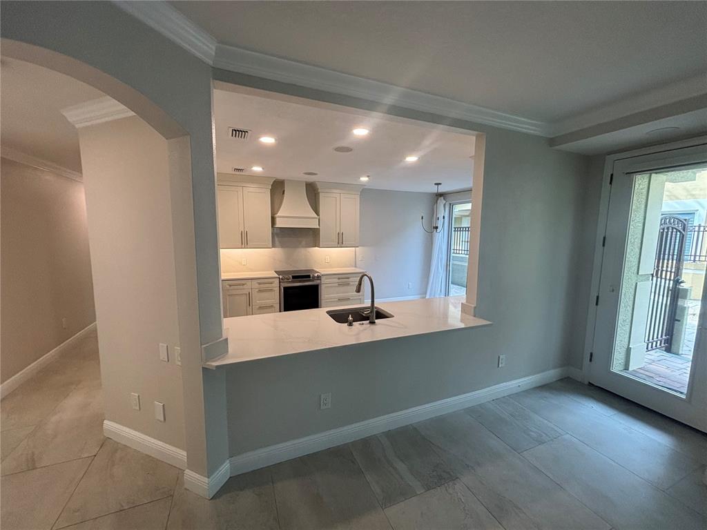 6536 Moorings Point Circle, Unit 101 Lakewood Ranch, FL 34202 - Photo 2 of 34 a view of kitchen with center island and stainless steel appliances