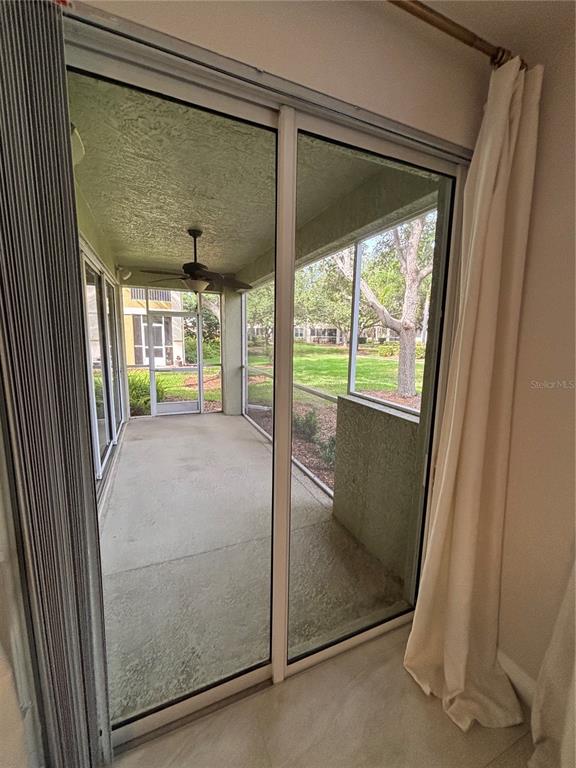 6536 Moorings Point Circle, Unit 101 Lakewood Ranch, FL 34202 - Photo 23 of 34 a view of a hallway with wooden floor and door
