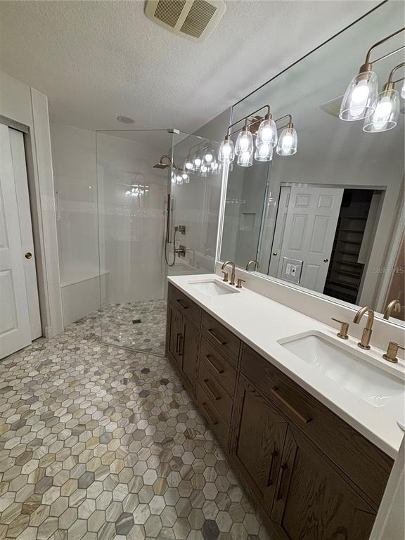 6536 Moorings Point Circle, Unit 101 Lakewood Ranch, FL 34202 - Photo 24 of 34 a bathroom with a sink double vanity and a mirror
