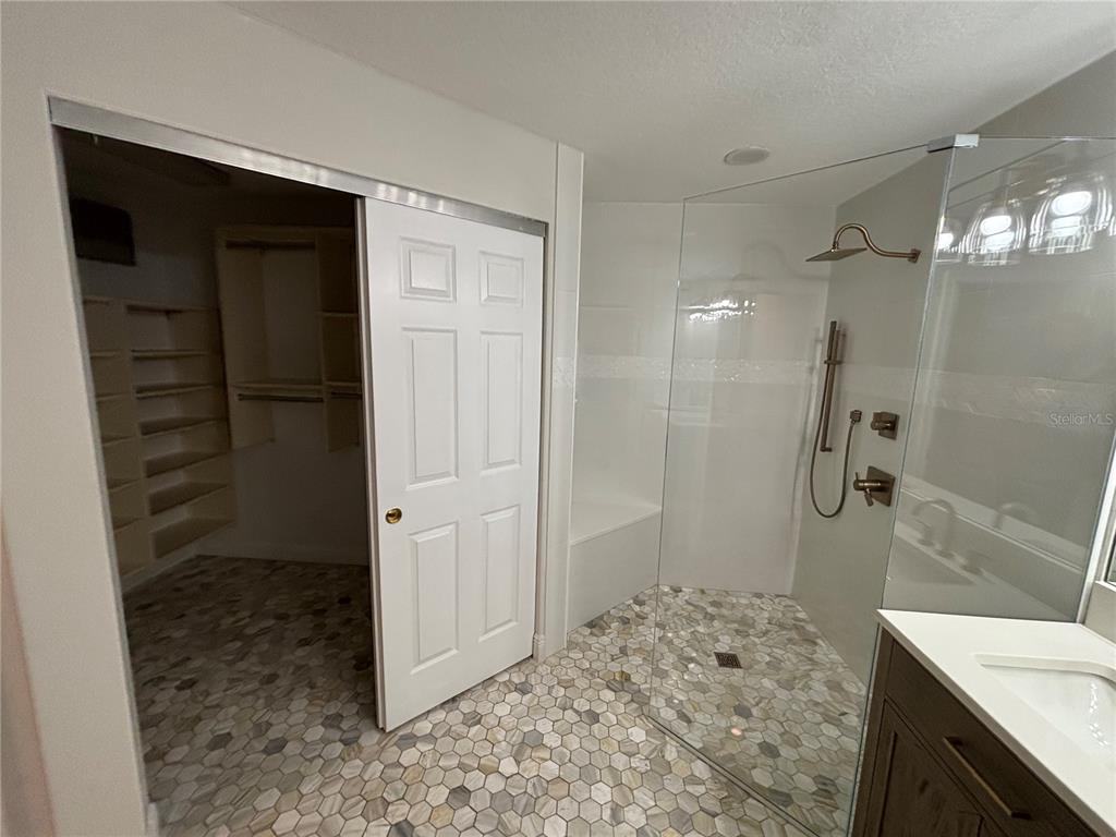 6536 Moorings Point Circle, Unit 101 Lakewood Ranch, FL 34202 - Photo 26 of 34 a bathroom with a shower and a sink