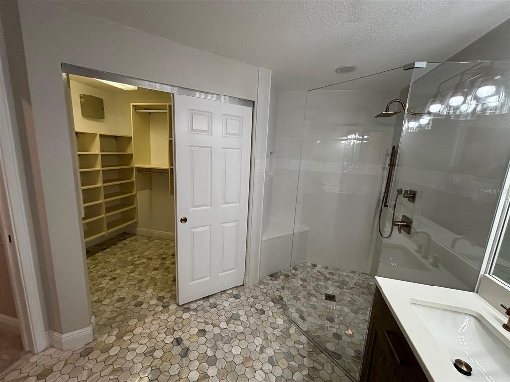 6536 Moorings Point Circle, Unit 101 Lakewood Ranch, FL 34202 - Photo 29 of 34 a bathroom with a sink and a shower