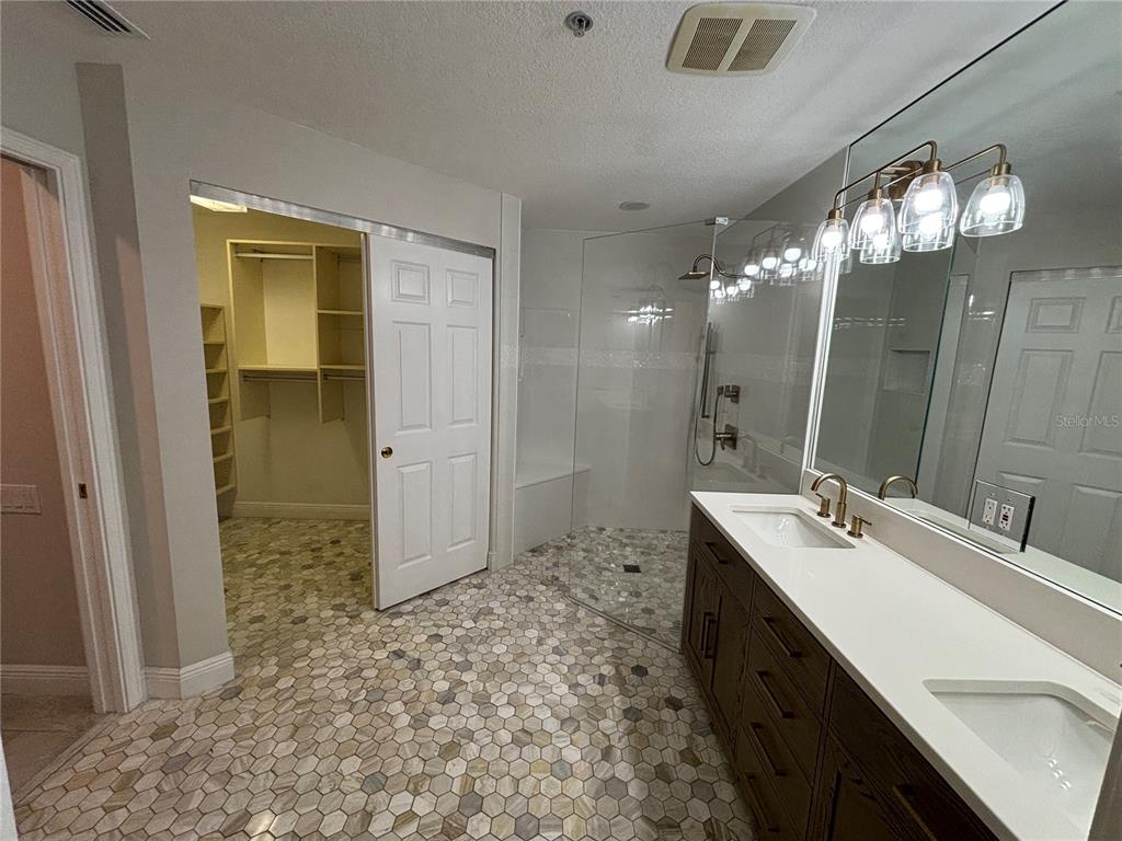 6536 Moorings Point Circle, Unit 101 Lakewood Ranch, FL 34202 - Photo 30 of 34 a bathroom with a sink double vanity and a mirror